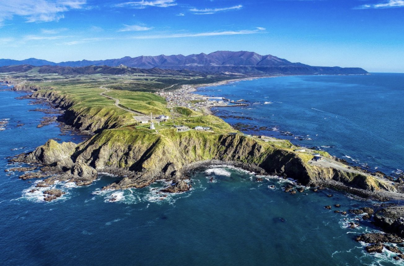 Aerial view of Cape Erimo, the green headland and rocky reefs at Hokkaido’s southern tip